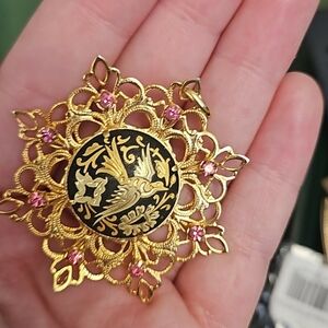 Elegant Gold and Black Pendant with Pink Accents